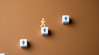 A stick man illustration climbing up.